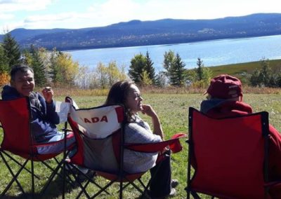 Campers relaxing enjoying the lake view